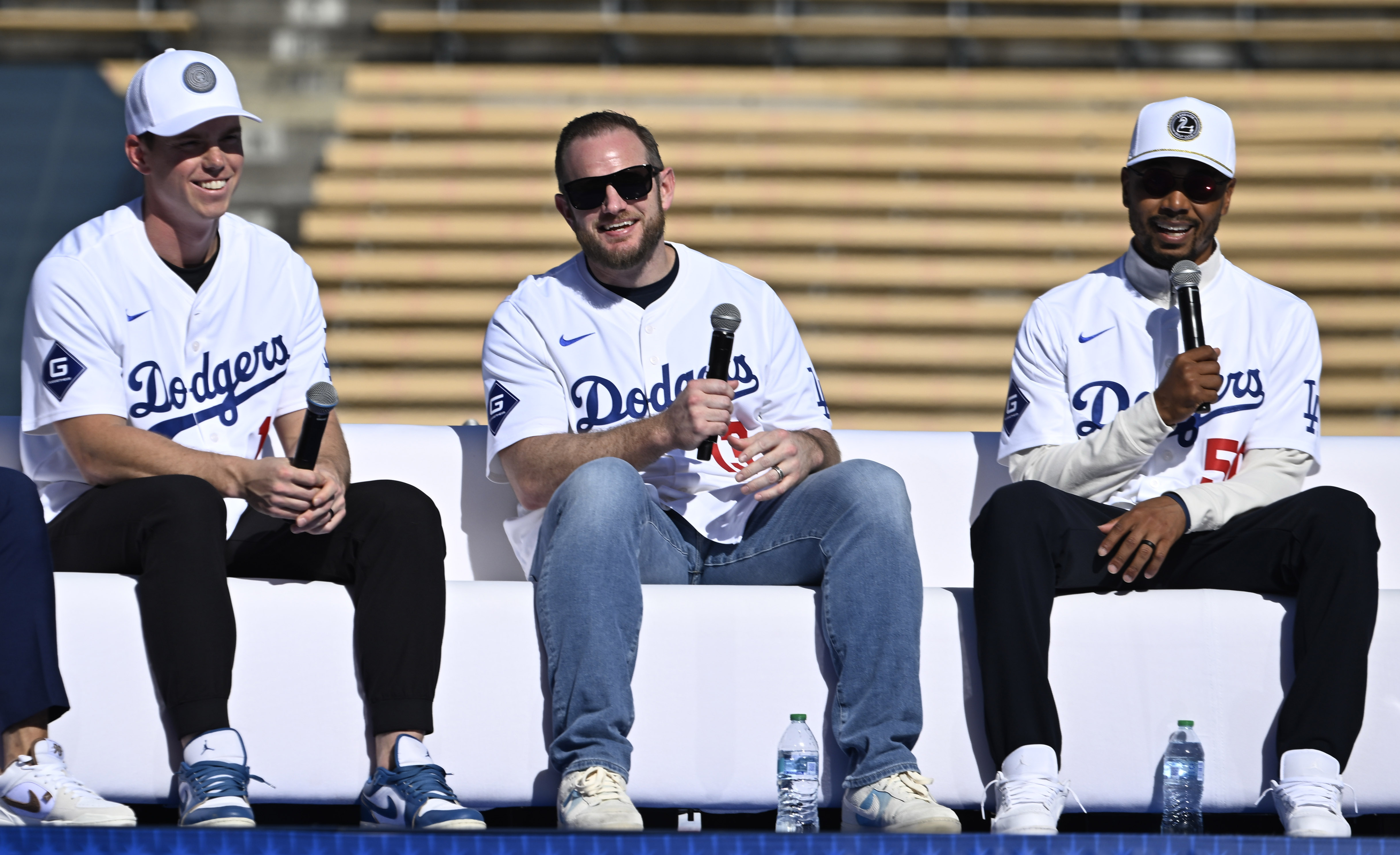 Will Smith, left, along with Max Muncy, center, listen as...