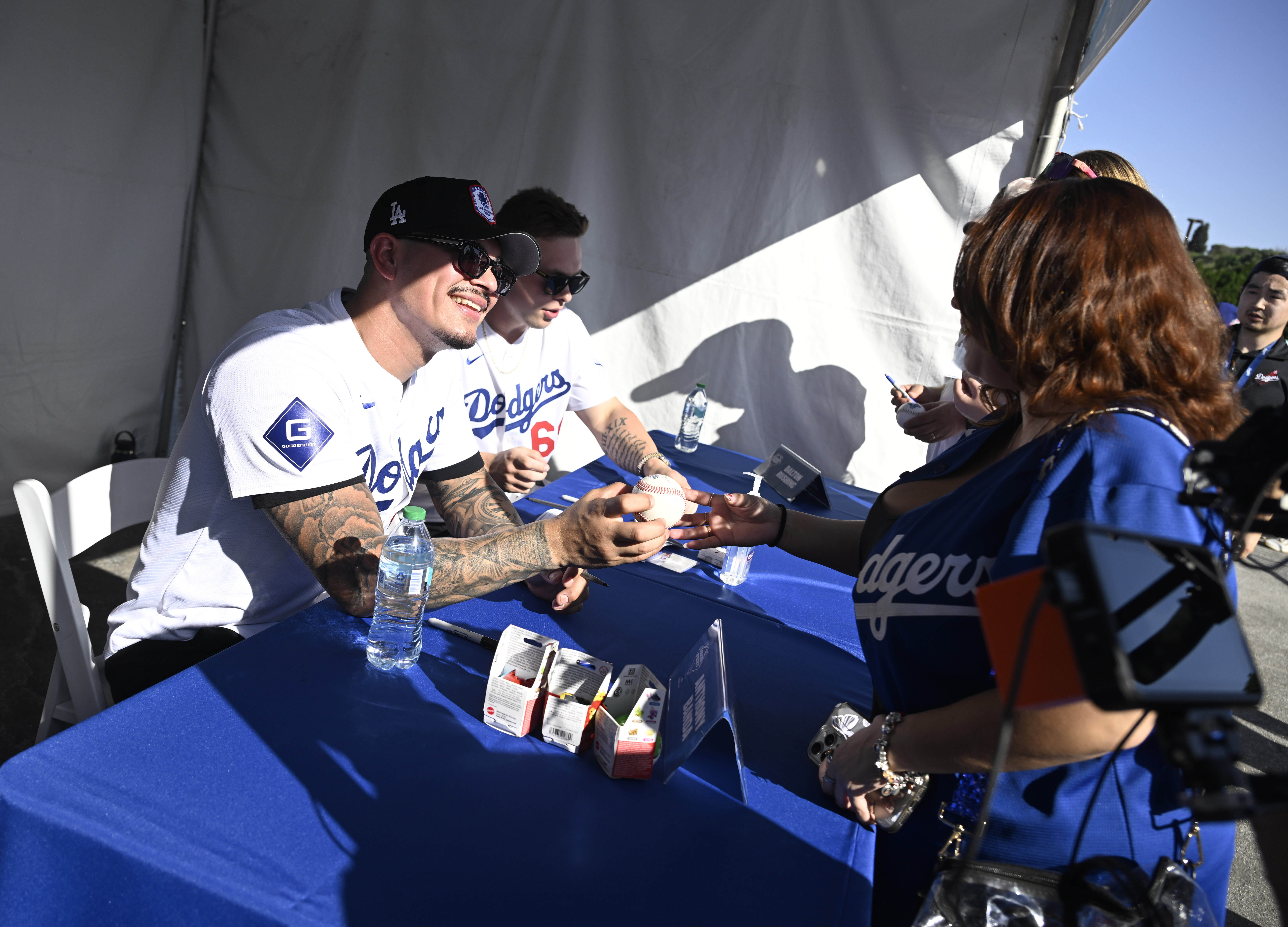 Anthony Banda of the Los Angeles Dodgers signs autographs during...