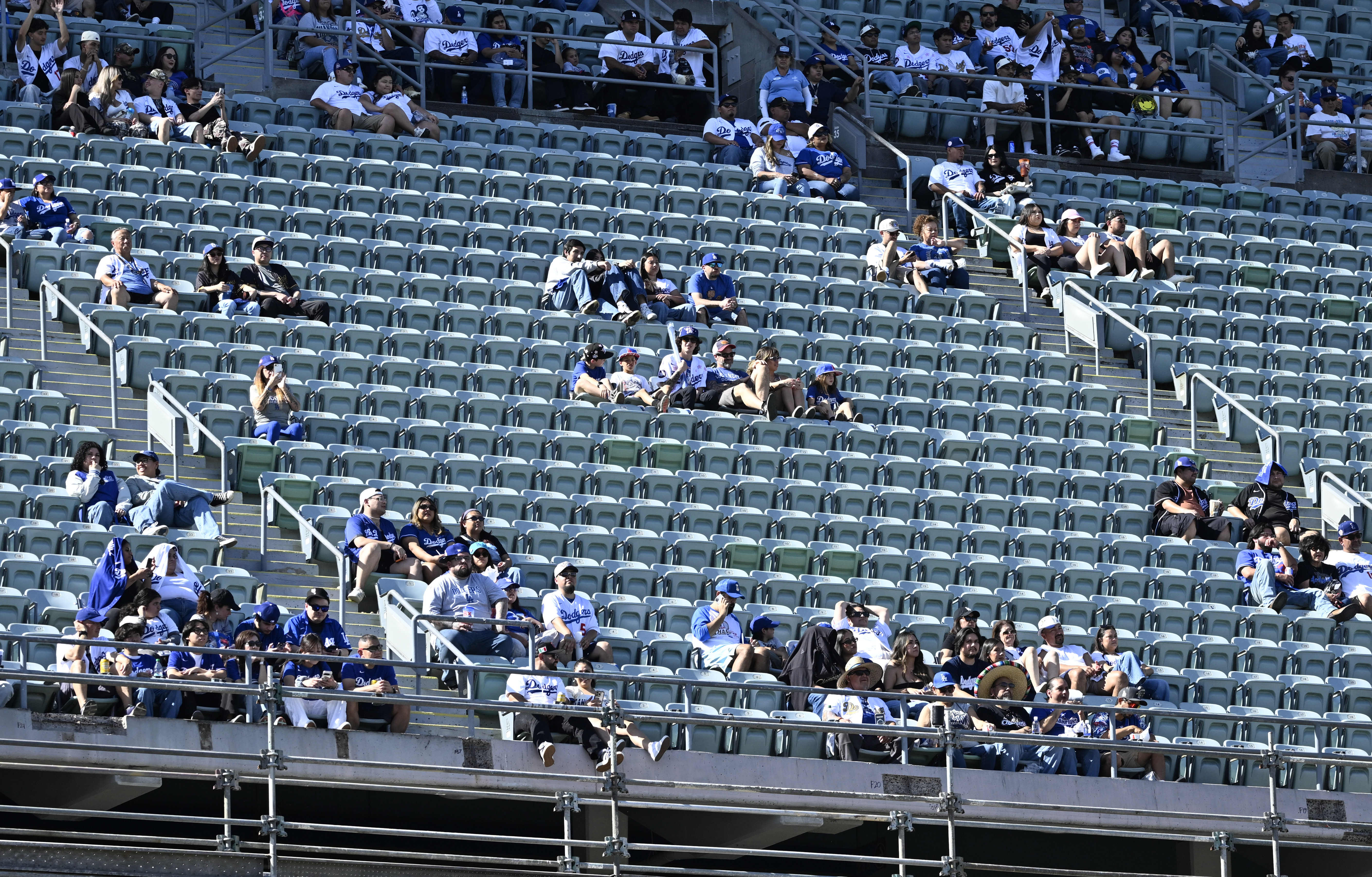 Dodger fans look on during a stage show during the...