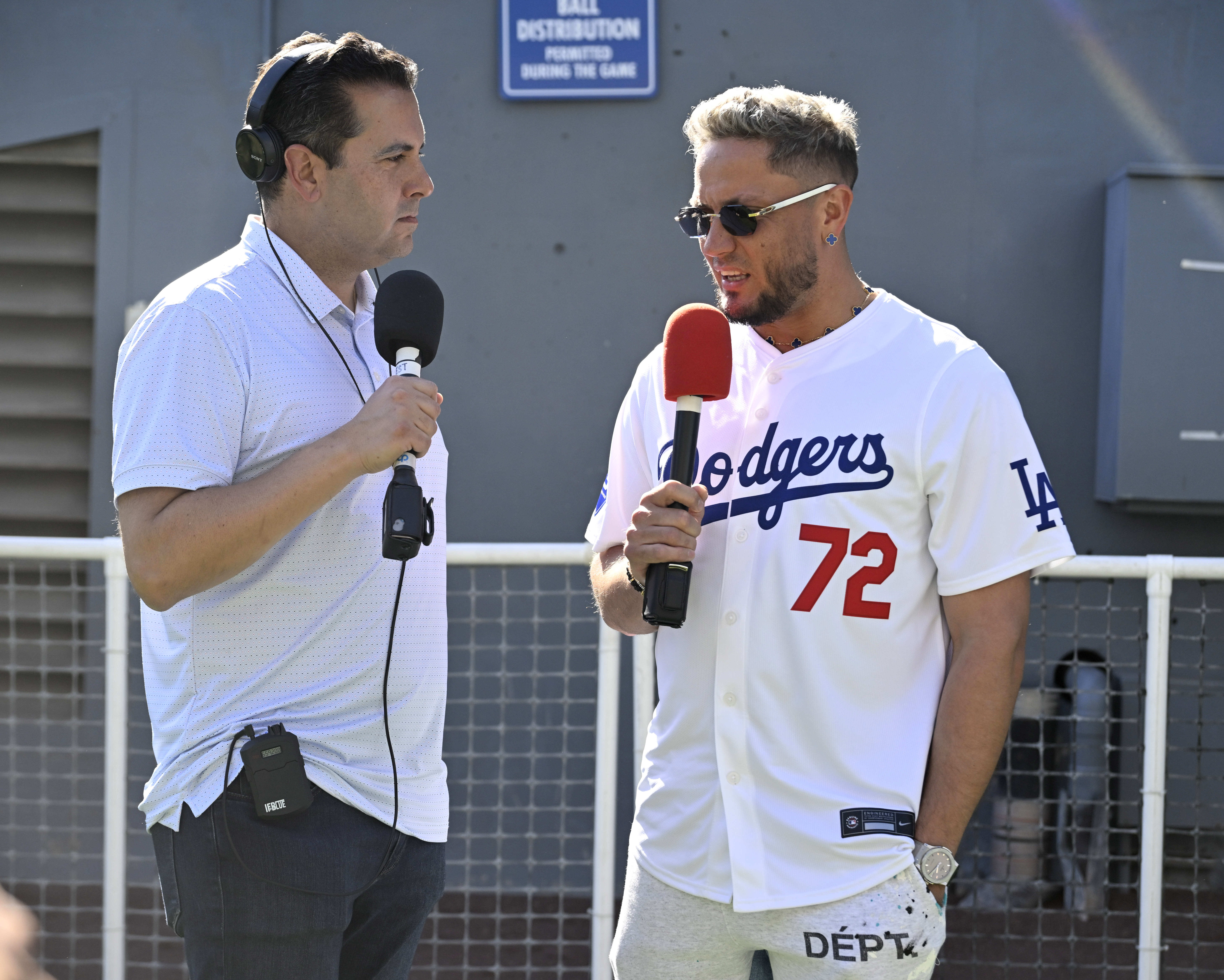Miguel Rojas, right, of the Los Angeles Dodgers speaks with...