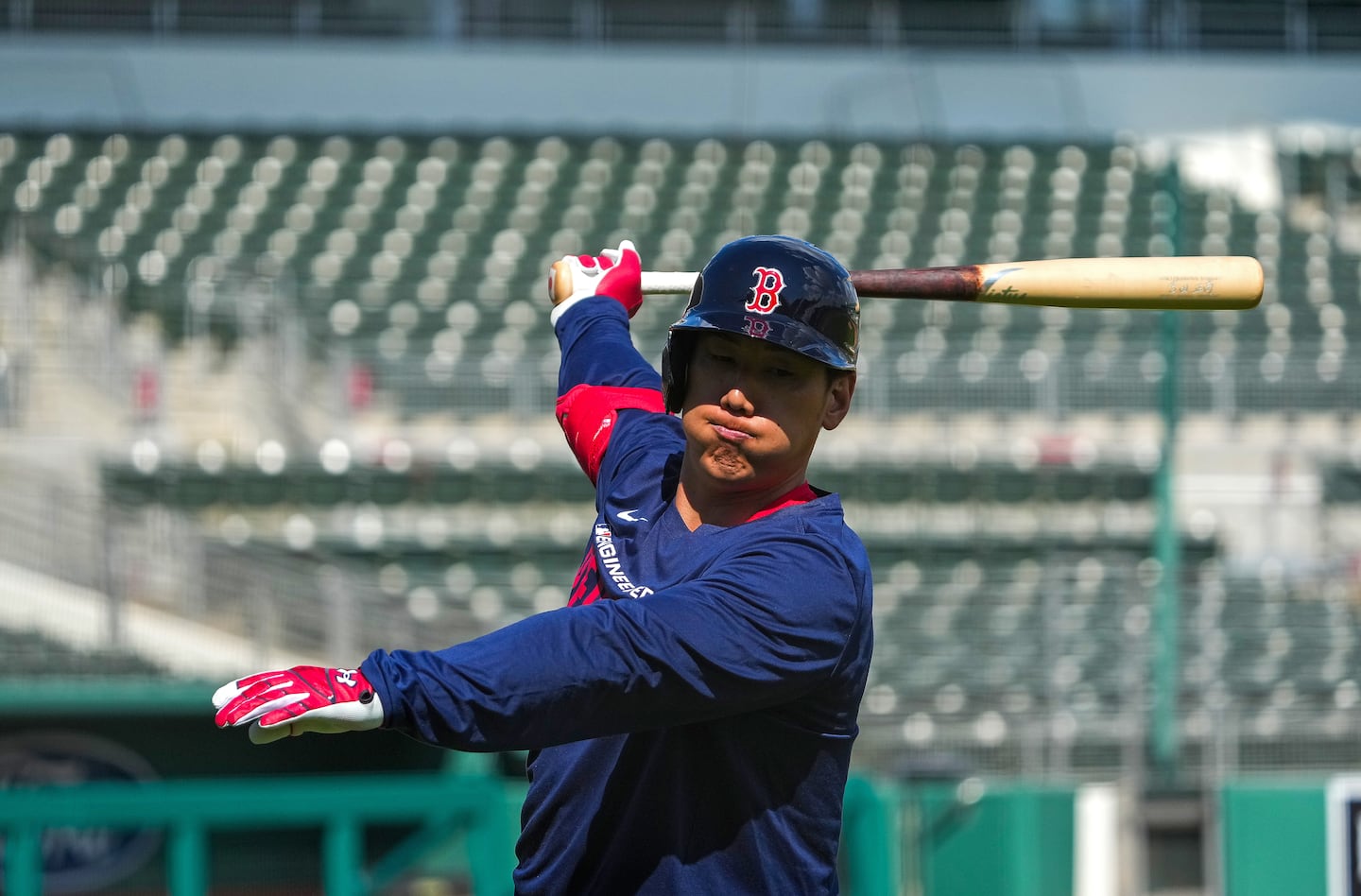Masataka Yoshida loosens up before taking live batting practice inside Jet Blue Park Saturday, Day 5 of spring training.