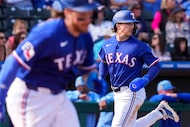 Texas Rangers infielder Cameron Cauley heads toward home as catcher Willie MacIver sprints...