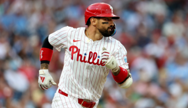 Philadelphia Phillies outfielder Nick Castellanos stands in the dugout during a 2025 game as the team moves toward a spring training split.