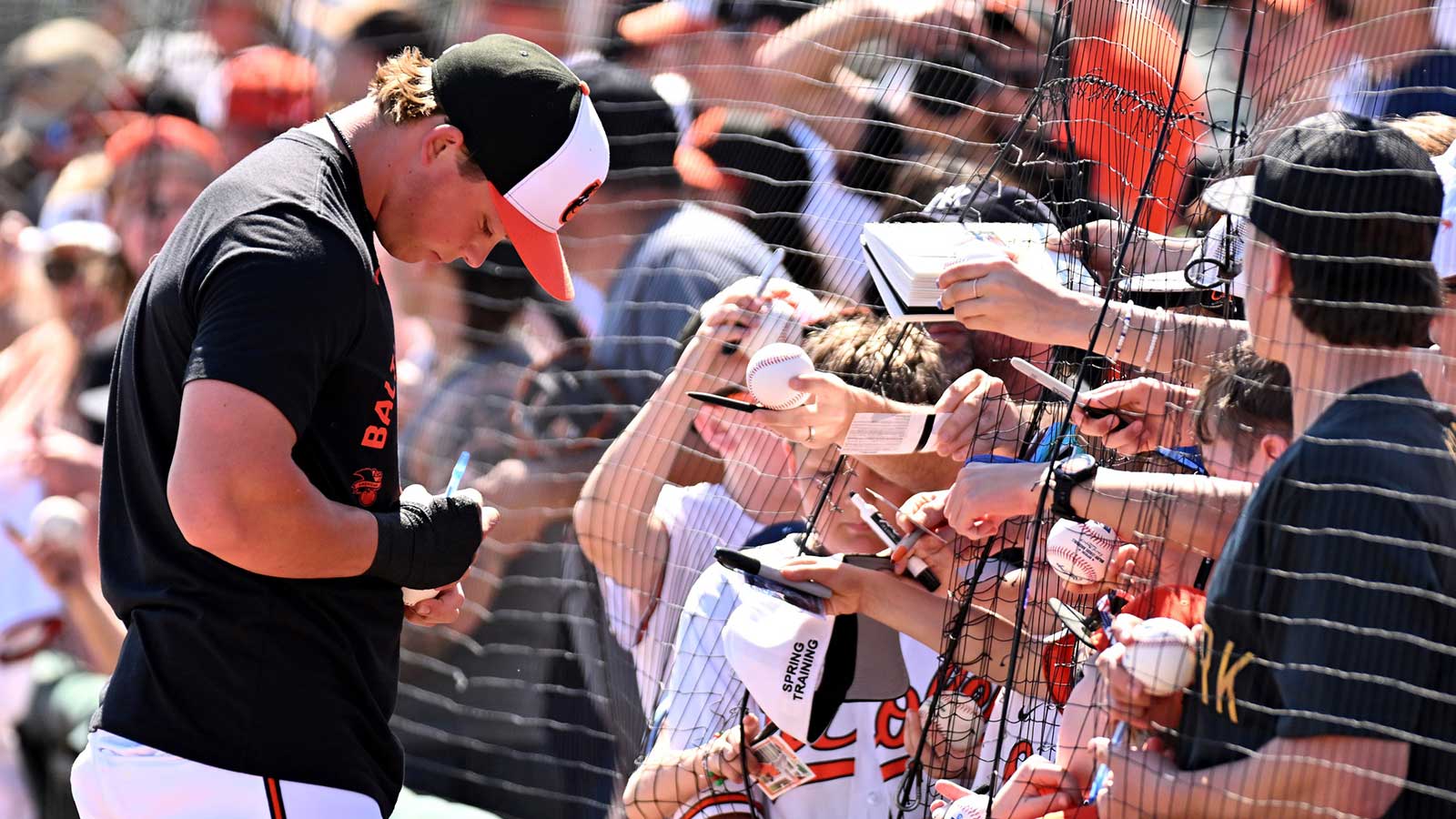 Baltimore Orioles infielder Jackson Holliday (7) signs autographs before the start of the spring training game against the New York Yankees at Ed Smith Stadium.