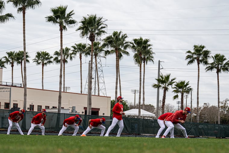 Philadelphia Phillies players work out during the first day of pitchers and catchers practice at BayCare Ballpark in Clearwater, Fla.