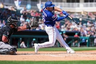 Texas Rangers outfielder Wyatt Langford drives in a run with first inning single in his...