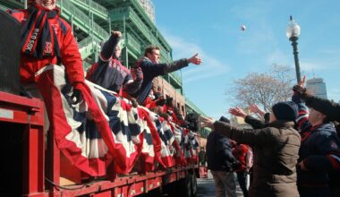 Red Sox fans reached for baseballs during Truck Day outside Fenway Park in 2014.
