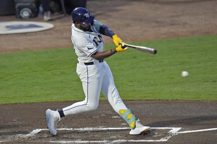Tampa Bay Rays' Junior Caminero lines an RBI single off Seattle Mariners pitcher Bryan Woo during the first inning of a baseball game Tuesday, Sept. 2, 2025, in Tampa, Fla. (AP Photo/Chris O'Meara)