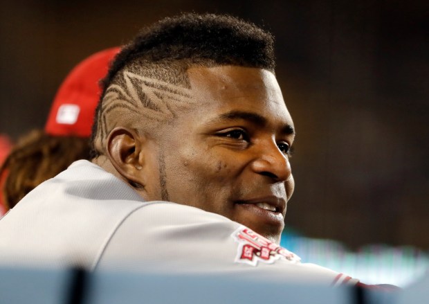 Cincinnati Reds' Yasiel Puig watches from the dugout during the fourth inning of the team's baseball game against the Los Angeles Dodgers on Tuesday, April 16, 2019, in Los Angeles. (AP Photo/Marcio Jose Sanchez)