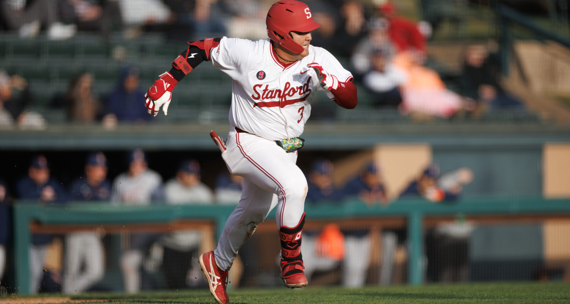 Baseball player runs on field.