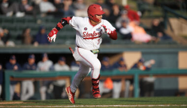 Baseball player runs on field.