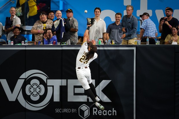 Padres right fielder Fernando Tatis Jr. makes a catch to rob the Reds' Tyler Stephenson of a home run on Tuesday. (Meg McLaughlin / The San Diego Union-Tribune)