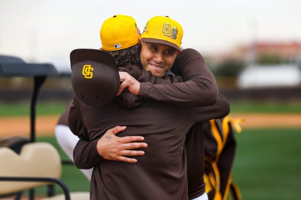 Manny Machado #13 of the San Diego Padres hugs Trevor Hoffman during spring training workouts at the Peoria Sports Complex on Friday, Feb. 13, 2026 in Peoria, Ariz.. (Meg McLaughlin / The San Diego Union-Tribune)