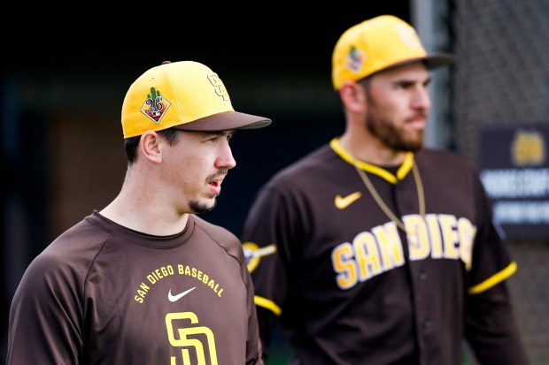 Walker Buehler and Joe Musgrove #44 of the San Diego Padres walk to the field during spring training workouts at the Peoria Sports Complex on Tuesday, Feb. 17, 2026 in Peoria, Ariz.(Meg McLaughlin / The San Diego Union-Tribune)