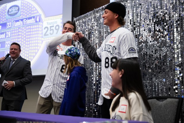 Rockies player Charlie Condon, left, daps up rookie Ethan Holliday during a Family Feud style game played during Rockies Fest on Saturday, Jan. 24, 2026, at Coors Field in Denver. (Photo by Timothy Hurst/The Denver Post)