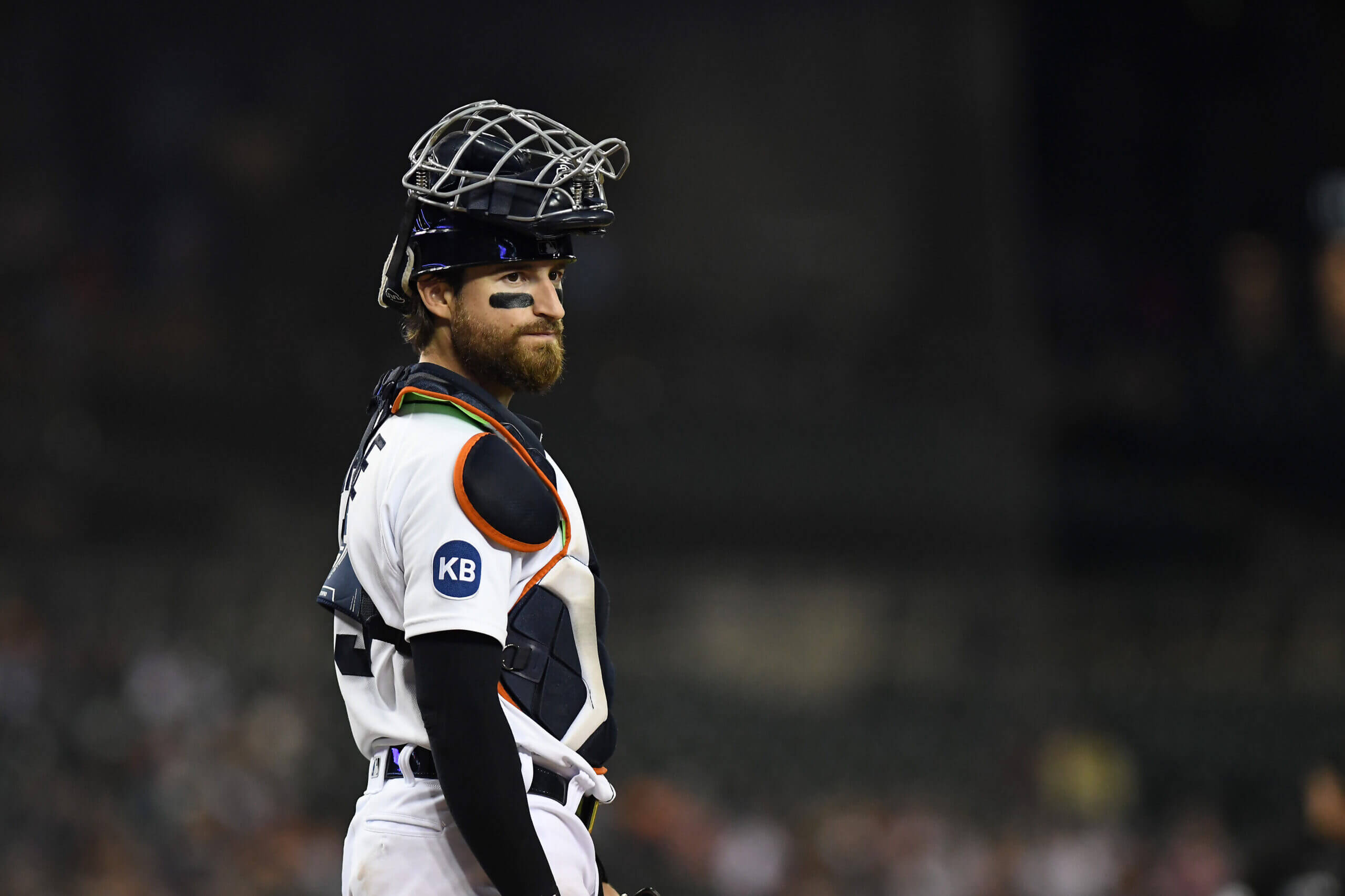 Eric Haase looks on with his catcher's mask on his head during a game for the Detroit Tigers.