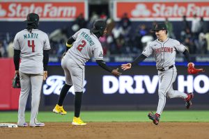 Apr 2, 2025; Bronx, New York, USA; Arizona Diamondbacks outfielder Corbin Carroll (7) celebrates with shortstop Geraldo Perdomo (2) and second baseman Ketel Marte (4) after defeating the New York Yankees at Yankee Stadium. Mandatory Credit: Vincent Carchietta-Imagn Images