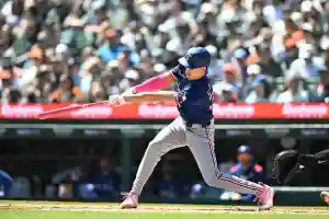 May 11, 2025; Detroit, Michigan, USA; Texas Rangers center fielder Evan Carter (32) hits an RBI single against the Detroit Tigers in the third inning at Comerica Park. Mandatory Credit: Lon Horwedel-Imagn Images