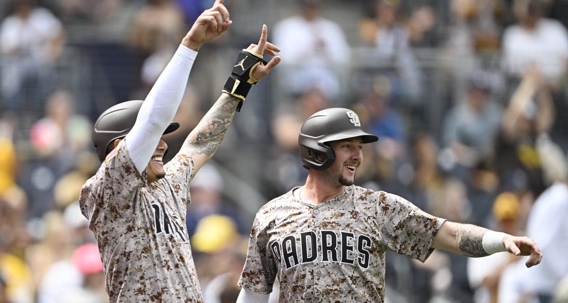Sep 28, 2025; San Diego, California, USA; San Diego Padres third baseman Manny Machado (13), left, and Jackson Merrill (3) celebrate after scoring during the first inning against the Arizona Diamondbacks at Petco Park.