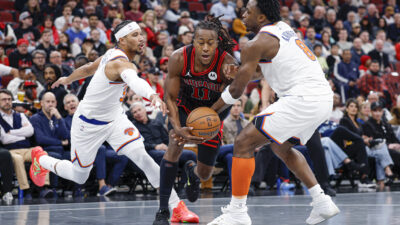 Oct 31, 2025; Chicago, Illinois, USA; Chicago Bulls guard Ayo Dosunmu (11) drives to the basket between New York Knicks forward OG Anunoby (8) and guard Josh Hart (3) during the first half at United Center.