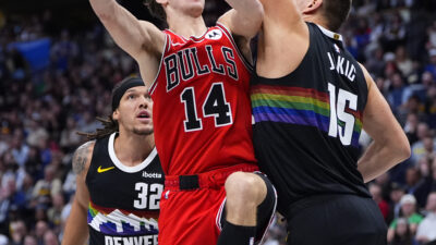 Nov 17, 2025; Denver, Colorado, USA; Chicago Bulls forward Matas Buzelis (14) shoots the ball over Denver Nuggets center Nikola Jokic (15) in the second quarter at Ball Arena.