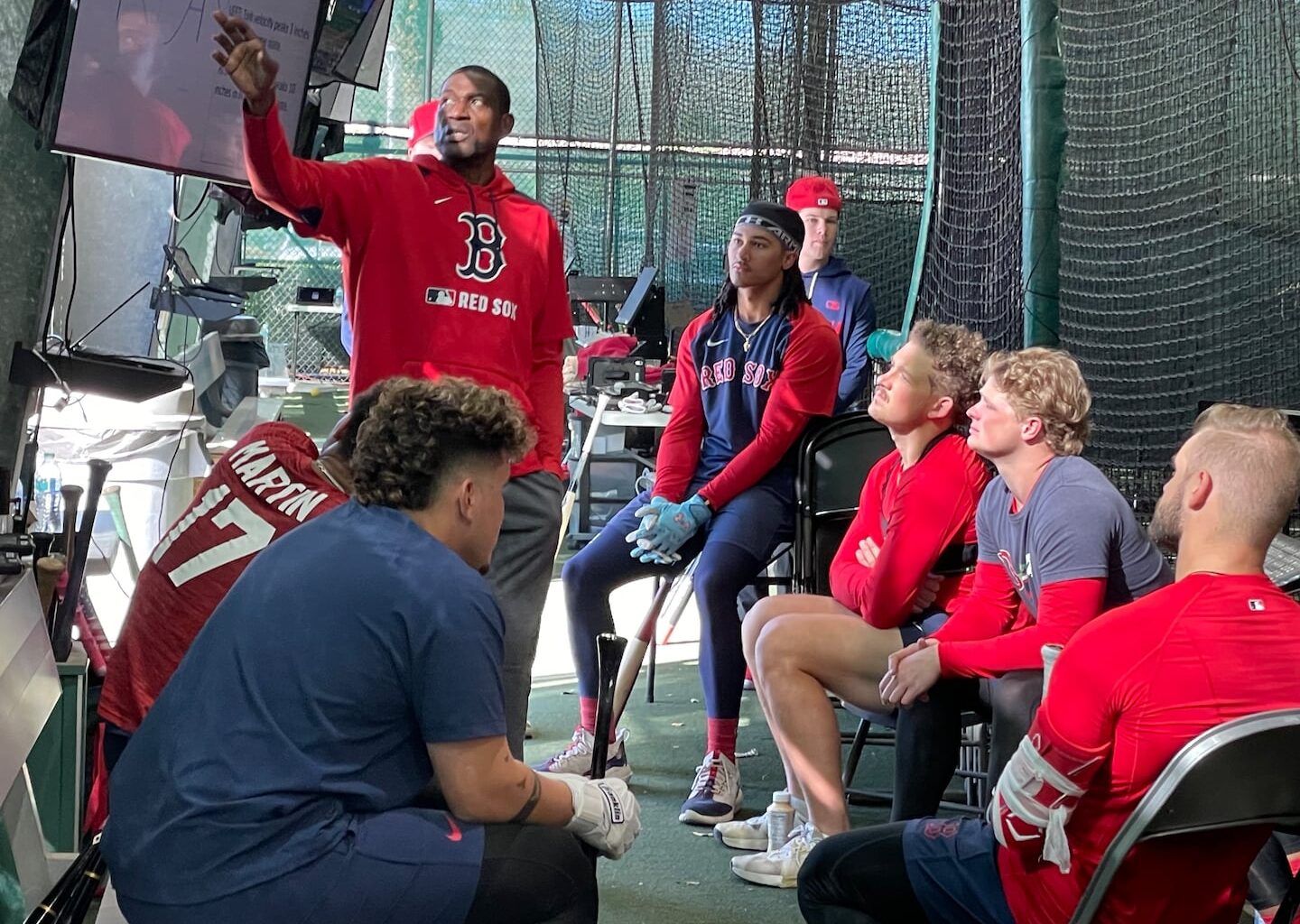 Red Sox minor league hitting coach Junior Zamora (standing) leads an education session for prospects on hitting contact points at the team's facility in Fort Myers, Fla..