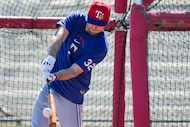 Texas Rangers outfielder Evan Carter takes batting practice during a spring training workout...