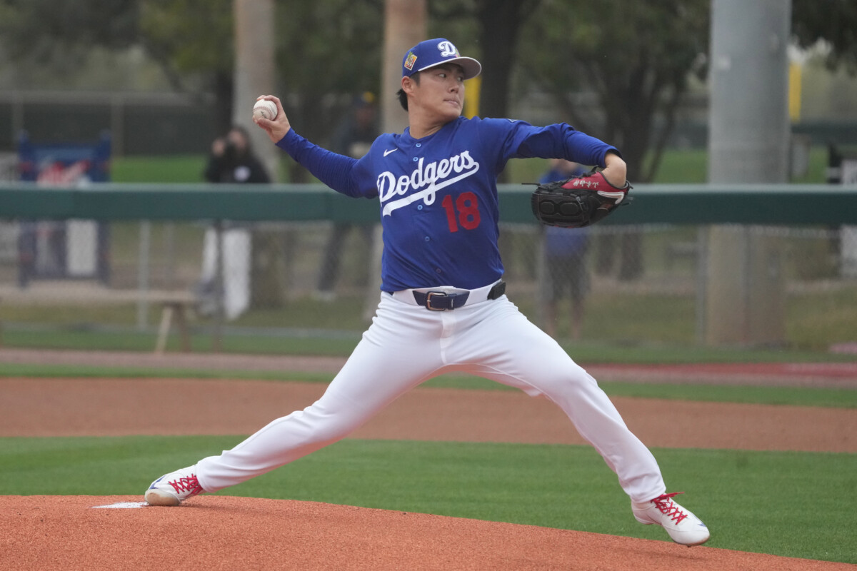 Los Angeles Dodgers pitcher Yoshinobu Yamamoto (18) throws from the mound during spring training camp.