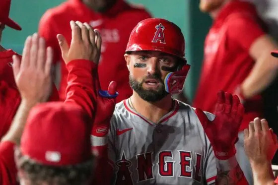 Aug 20, 2024; Kansas City, Missouri, USA; Los Angeles Angels center fielder Kevin Pillar (12) is congratulated in the dugout against the Kansas City Royals after scoring in the sixth inning at Kauffman Stadium. Mandatory Credit: Denny Medley-USA TODAY Sports