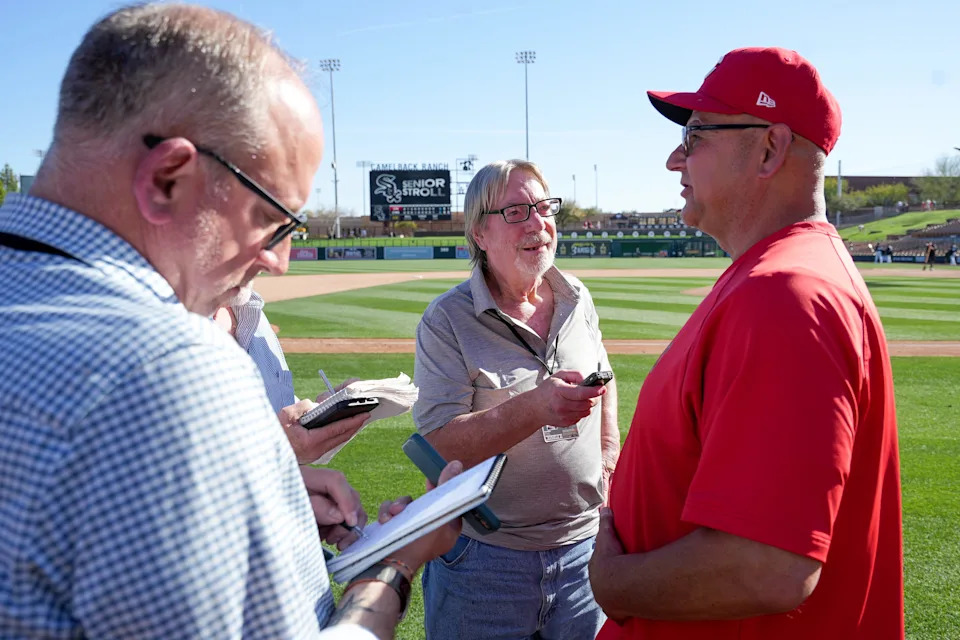 Associated Press contributor Gary Schatz, middle, interviews Cincinnati Reds manager Terry Francona, right, after a 3-2 win against the Chicago White Sox during a Cactus League game, Wednesday, Feb. 25, 2026, at Camelback Ranch Stadium in Glendale, Ariz.