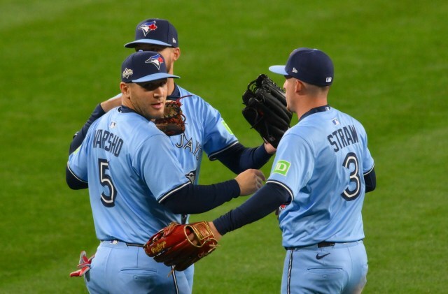 Blue Jays outfielders gather during the ALCS in Seattle