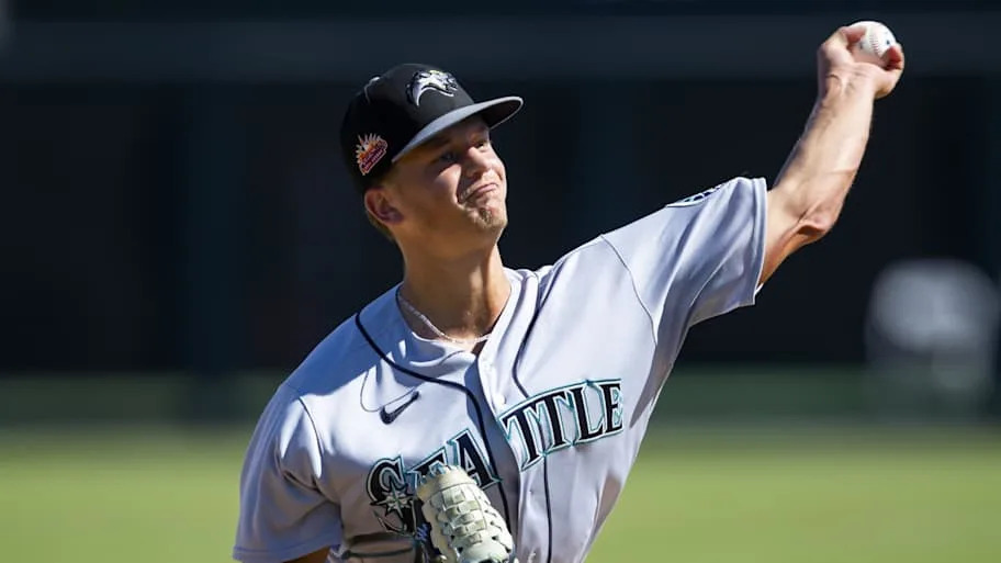 Adam Macko throws a baseball in a gray Mariners unifor