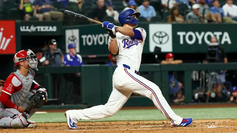 Texas Rangers Corey Seager swinging a baseball ba