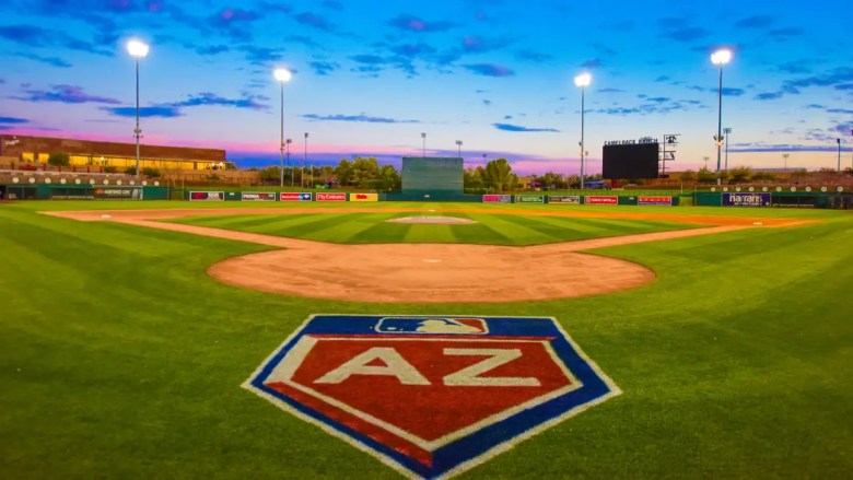 A baseball field at sunset with the "AZ" logo on the grass.