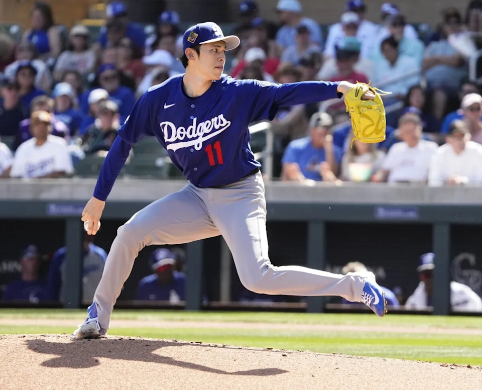 Los Angeles Dodgers pitcher Roki Sasaki (11) throws to the Arizona Diamondbacks in the first inning on Feb. 25, 2026, at Salt River Fields in Scottsdale.