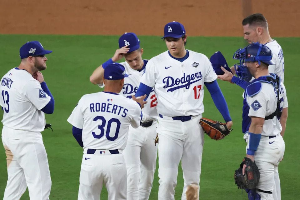 Oct 28, 2025; Los Angeles, California, USA; Los Angeles Dodgers manager Dave Roberts (30) pulls Los Angeles Dodgers two-way player Shohei Ohtani (17) from pitching during the seventh inning against the Toronto Blue Jays during game four of the 2025 MLB World Series at Dodger Stadium. Mandatory Credit: Kiyoshi Mio-Imagn Images