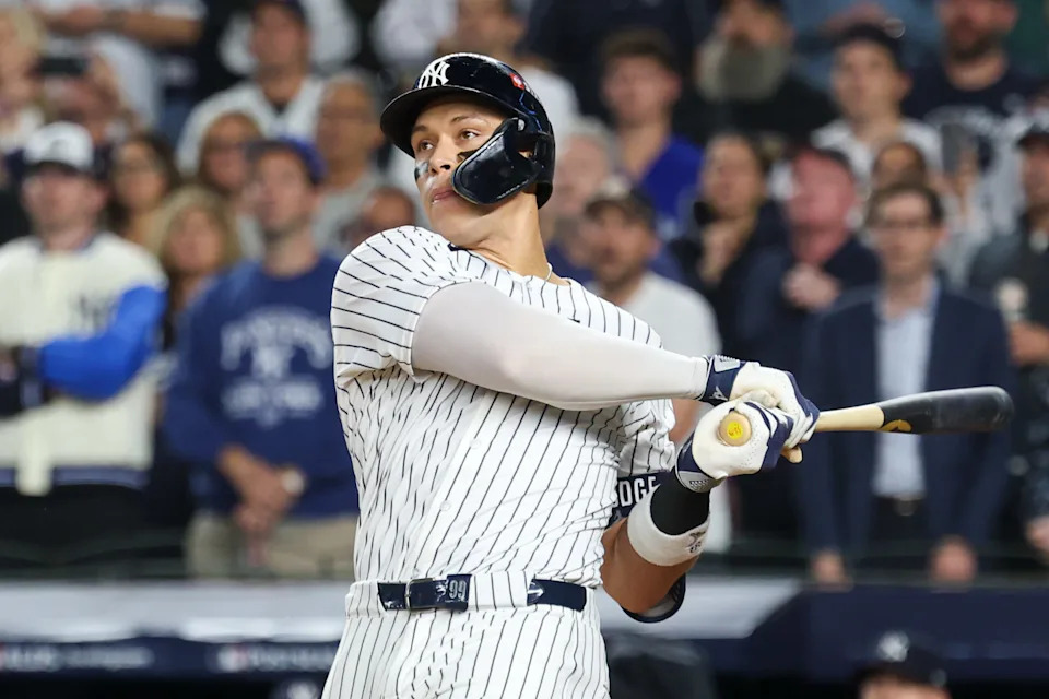 Oct 7, 2025; Bronx, New York, USA; New York Yankees outfielder Aaron Judge (99) hits a three-run home run in the fourth inning against the Toronto Blue Jays during game three of the ALDS round for the 2025 MLB playoffs at Yankee Stadium. Mandatory Credit: Vincent Carchietta-Imagn Images