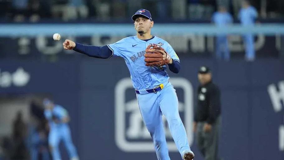 Toronto Blue Jays shortstop Andres Gimenez throws to first.