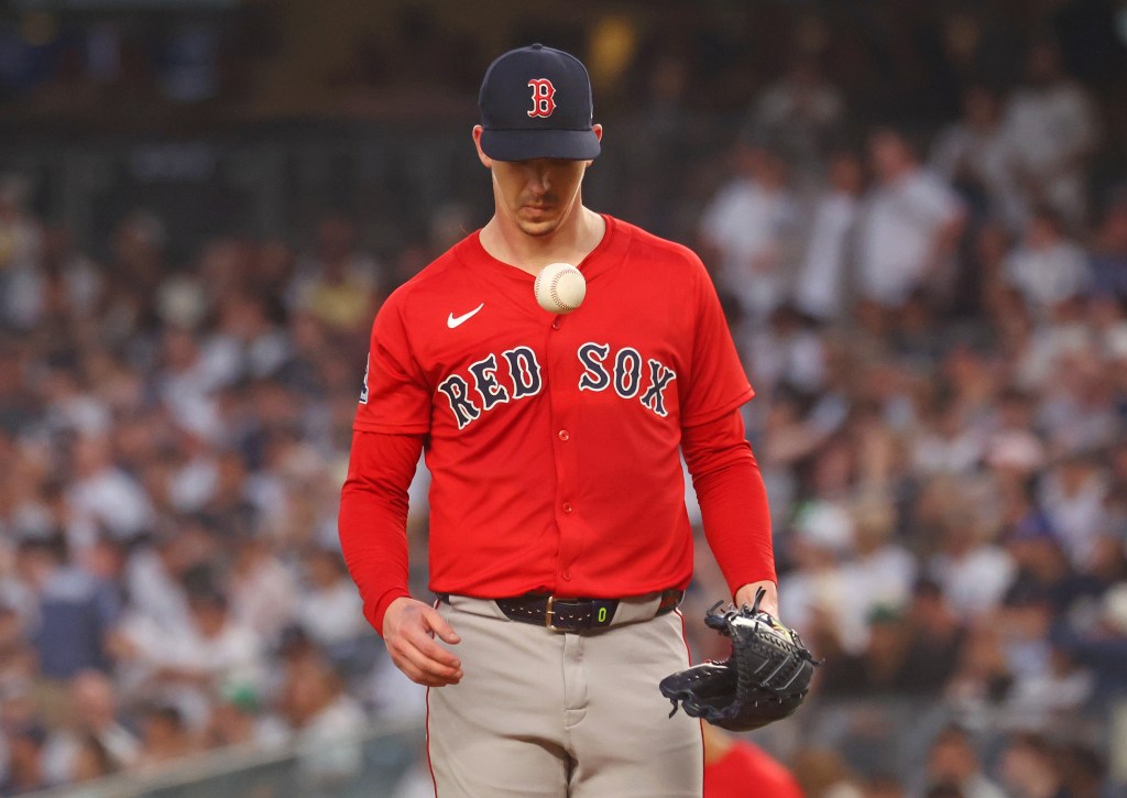 Cleveland Guardians pitcher Walker Buehler in a red jersey, with a baseball visible floating in front of him.
