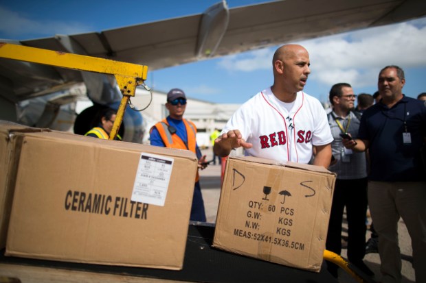Carolina, Puerto Rico - January 30, 2018: Boston Red Sox manager Alex Cora unloads boxes of supplies at Luis Munoz Marin Airport to help Hurricane Maria victims. Players and officials also made the trip. Ramon " Tonito " Zayas / GFR Media/Ap Photos