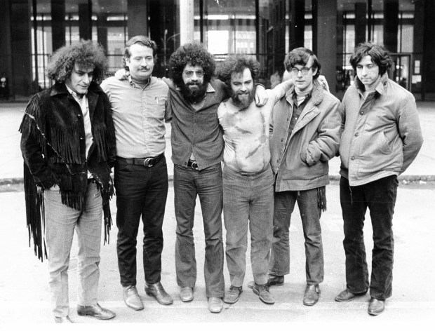 Six of the Chicago Seven defendants pose outside the Federal Building in Chicago during their conspiracy trial in February 1970. From left are: Abbie Hoffman, John Froines, Lee Weiner, Jerry Rubin, Rennie Davis and Tom Hayden. (William Yates/Chicago Tribune)