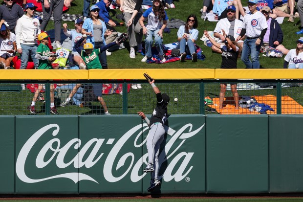 Chicago White Sox center fielder Derek Hill (25) jumps for a solo-homer hit by Chicago Cubs right fielder Seiya Suzuki (27) in the first inning during the Cubs and White Sox first spring training game of the year at Sloan Park Friday Feb. 20, 2026 in Mesa, Ariz. (Armando L. Sanchez/Chicago Tribune)