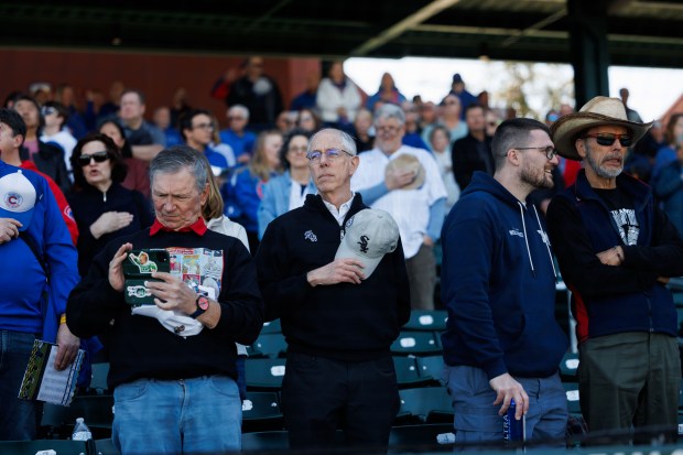 Fans stand during the national anthem before the Chicago Cubs play the Chicago White Sox during the Cubs and White Sox first spring training game of the year at Sloan Park Friday Feb. 20, 2026 in Mesa, Ariz. (Armando L. Sanchez/Chicago Tribune)