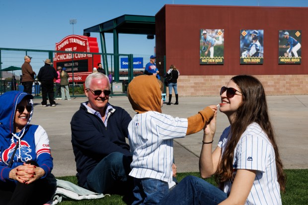 Melanie Studnicka, 32, gets chapstick put on by her two-year-old son before the Cubs play against the Chicago White Sox during the Cubs and White Sox first spring training game of the year at Sloan Park Friday Feb. 20, 2026 in Mesa, Ariz. (Armando L. Sanchez/Chicago Tribune)
