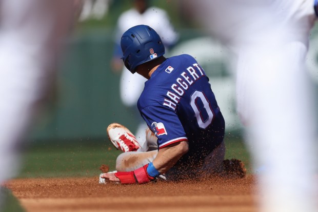 Texas Rangers second baseman Sam Haggerty (0) slides safely into second base during the first inning against the Chicago Cubs in a Cactus League game at Sloan Park Saturday Feb. 21, 2026 in Mesa, Ariz. (Armando L. Sanchez/Chicago Tribune)