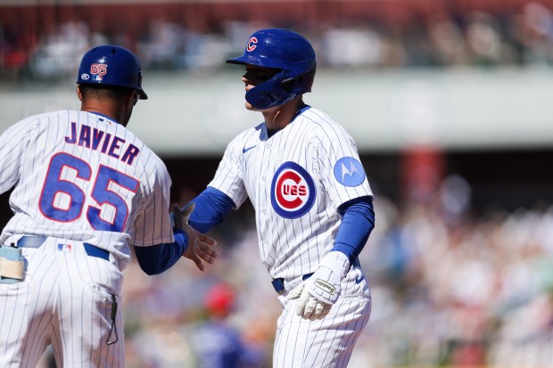 Chicago Cubs right fielder Matt Shaw (6) celebrates with Chicago Cubs first base coach Jose Javier (65) after hitting a single during the first inning against the Texas Rangers in a Cactus League game at Sloan Park Saturday Feb. 21, 2026 in Mesa, Ariz. (Armando L. Sanchez/Chicago Tribune)