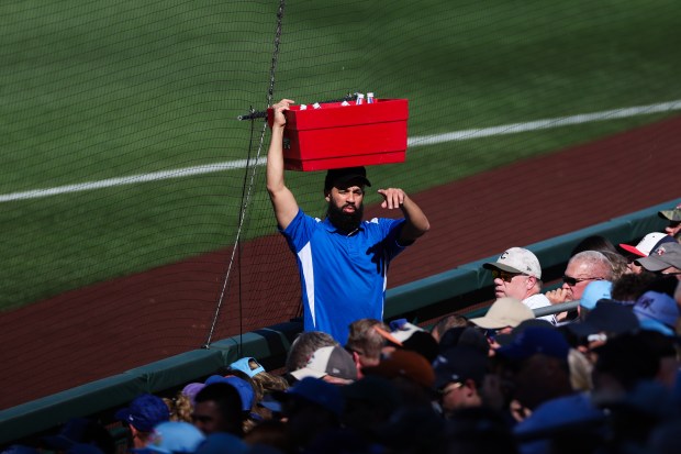 A vendor carries drinks on his head while the Chicago Cubs play the Texas Rangers during the fourth inning of a Cactus League game at Sloan Park Saturday Feb. 21, 2026 in Mesa, Ariz. (Armando L. Sanchez/Chicago Tribune)