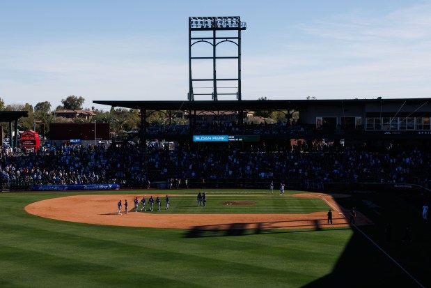 Texas Rangers players celebrate after defeating the Chicago Cubs, 3-2, in a Cactus League game at Sloan Park Saturday Feb. 21, 2026 in Mesa, Ariz. (Armando L. Sanchez/Chicago Tribune)