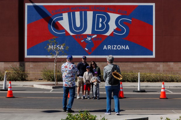 Fans take photos outside the ballpark before the Chicago Cubs play the Texas Rangers in a Cactus League game at Sloan Park Saturday Feb. 21, 2026 in Mesa, Ariz. (Armando L. Sanchez/Chicago Tribune)