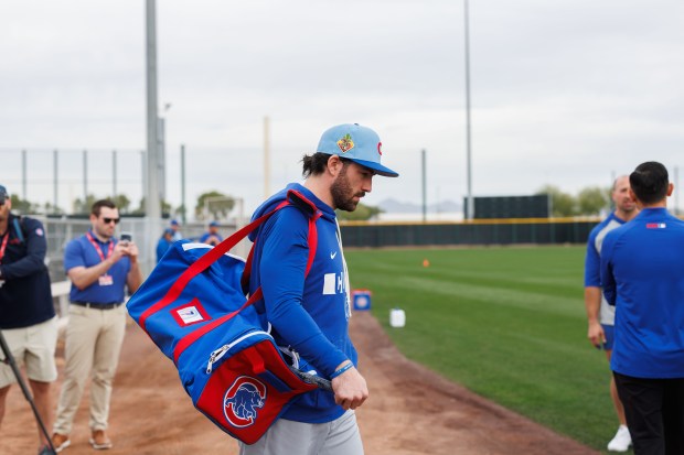 Dansby Swanson walks to a practice field before warming up during the first day of the Cubs full-squad workout at spring training at Sloan Park on Feb. 16, 2026, in Mesa, Ariz. (Armando L. Sanchez/Chicago Tribune)
